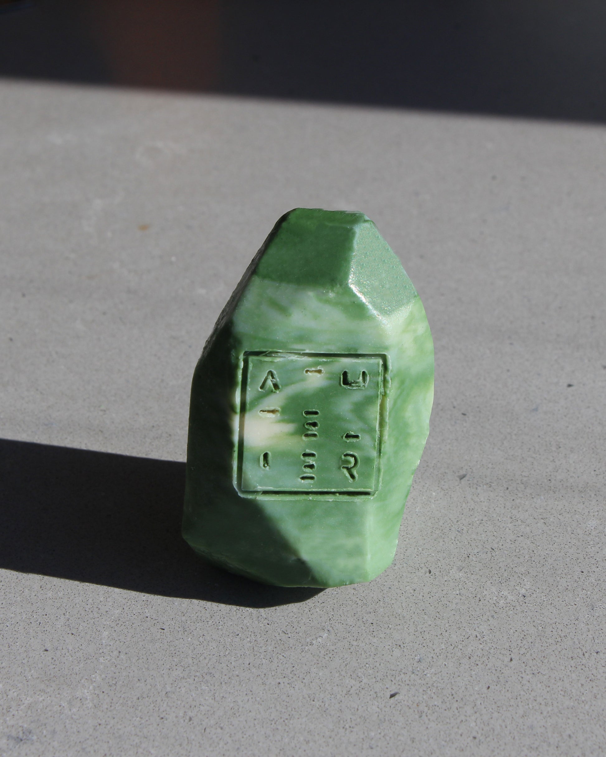 Green shampoo bar with embossed logo