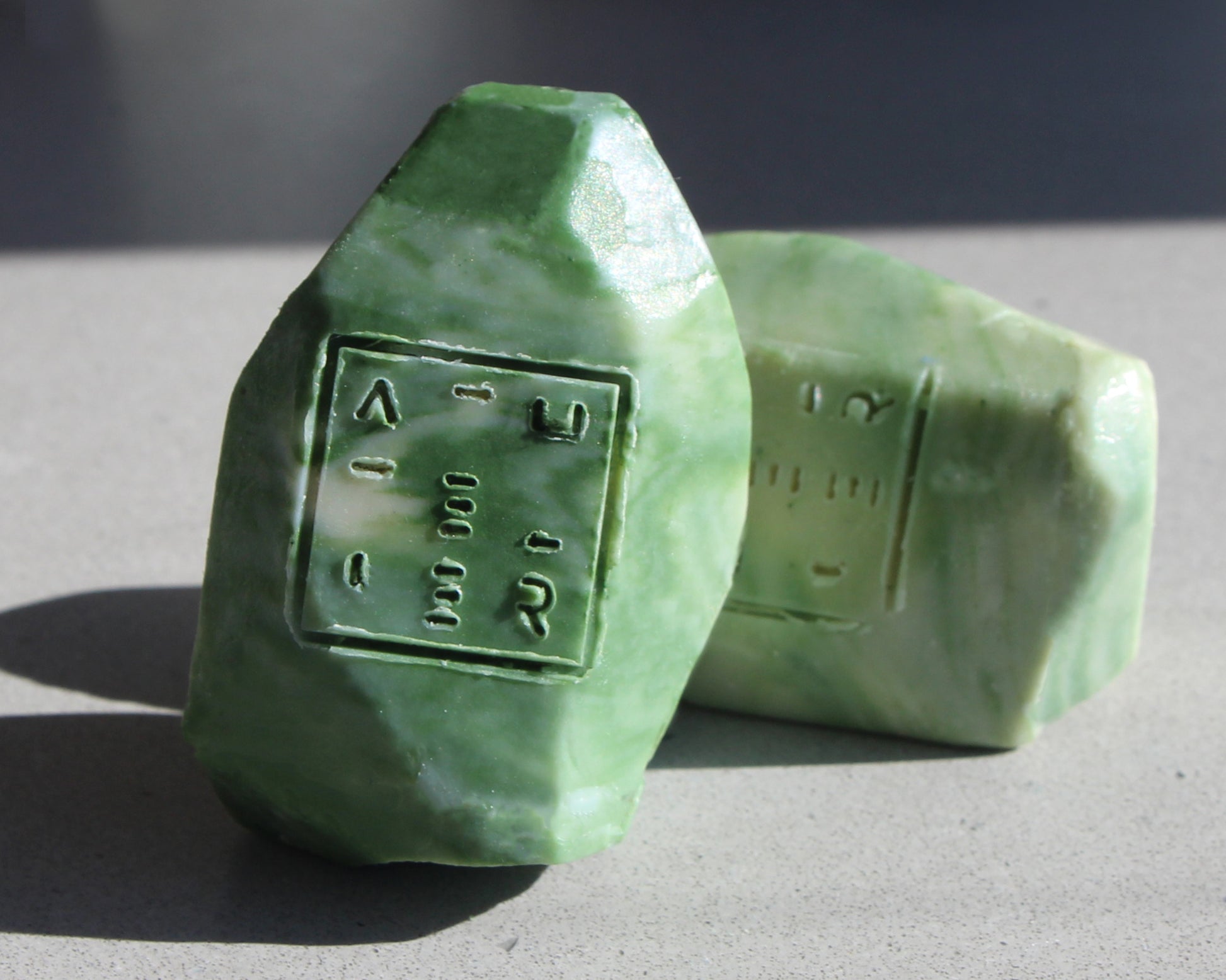 Green shampoo bars with embossed logo