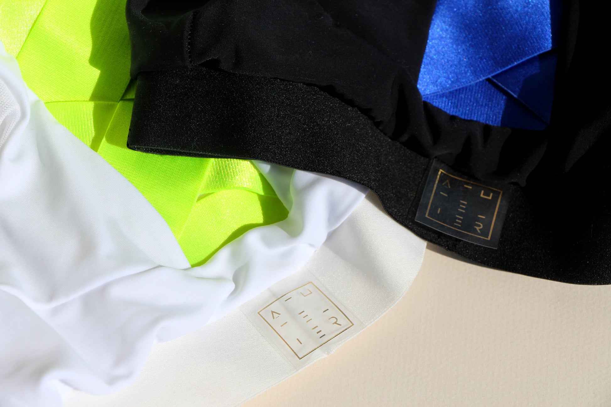 a close up shot of two sports bra waistbands, one in black and one in white